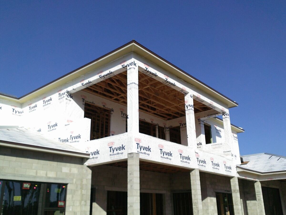 Two-story custom home wrapped in Tyvek house wrap during construction