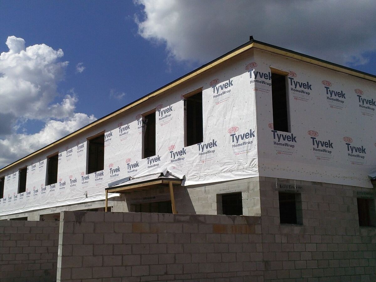 Window openings in a house-wrapped wall on new townhomes